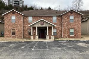 a brick building with a parking lot in front of it at Making Branson Memories - Unit 1 in Branson