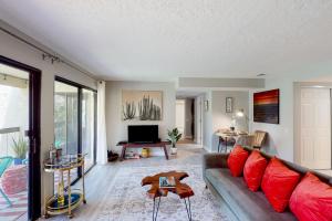 a living room with a couch and a tv at Riviera Gardens in Palm Springs