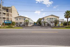 an empty street in front of some buildings at Sea & Sun 204 by Vacation Homes Collection in Gulf Shores