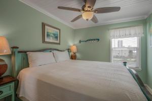 a bedroom with a bed with a ceiling fan at Sea & Sun 204 by Vacation Homes Collection in Gulf Shores
