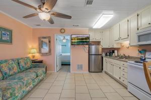 a living room with a couch and a kitchen at Sea & Sun 204 by Vacation Homes Collection in Gulf Shores