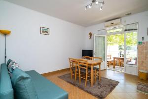 a living room with a blue couch and a table at Apartment Zuljana 10233b in Žuljana