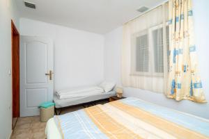 a bedroom with a bed and a window at Apartment Zuljana 10233b in Žuljana