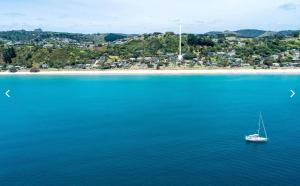 an aerial view of a boat in a body of water at Onetangi Beachfront Escape - Coast & Country in Onetangi