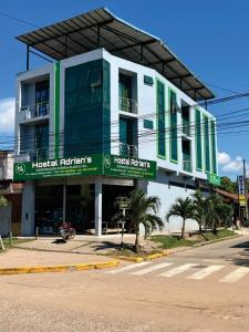 a building on the corner of a street with a street at Adrian´s Hotel in Pucallpa