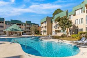an image of a swimming pool at a apartment complex at Classy & comfortable condo! in Hilton Head Island