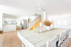 a kitchen and dining room with a table and chairs at The Scarborough Beach House - Walk to the beach! in Perth