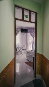 a door leading into a room with a bedroom at El Grano De Oro Hotel in Tupiza