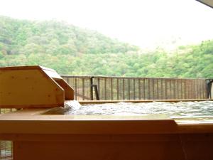 a wooden deck with a pool of water at Iwaiyado Jyuan Nikko Kawaji onsen in Nikko
