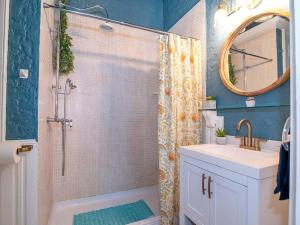 a bathroom with a shower and a sink and a mirror at Historic Victorian Studio Near City Park NOMA Bayou St John in New Orleans