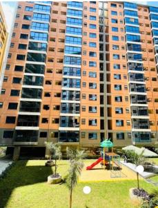 a large apartment building with a playground in front of it at Luxurious 2bedroom furnished apartment in Nairobi