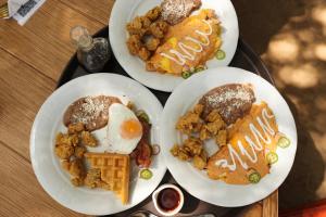 tres platos de desayuno en una mesa en Boskenvid Hotel Boutique, Skypool, en Valle de Guadalupe