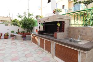 a outdoor kitchen with a sink on a patio at Vila Eni - Mario in Ksamil