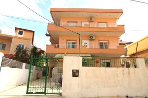 a building with a green gate in front of it at Vila Eni - Mario in Ksamil