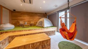 a room with a tent and a hammock in it at Relax Hotel Takayama Station in Takayama