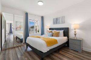 a bedroom with a large bed and a mirror at Stunning 2BR w/ 1BA Home near BART in Daly City