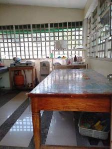a kitchen with a table in a room with windows at Triple N Homestay Beachfront House in Lobo in Lobo +42 photos