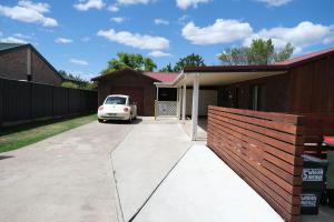 a white car parked in the driveway of a house at Twodogfolly at Creeklands in Armidale