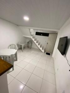 a room with a staircase and a white tiled floor at THE BROTHERS in Angra dos Reis