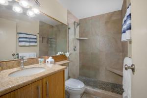 a bathroom with a sink and a toilet and a shower at Beautiful 1 Bedroom Condo with Ocean Views | Oceanfront in Kihei