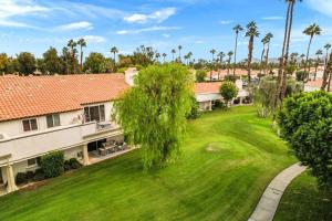 an aerial view of a house with a yard at Desert Falls Diamond - pool, spa, golf, views! in Palm Desert