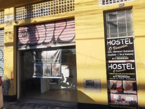 a window of a store with a hostel sign on it at Hostel O Vencedor in São Paulo