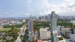 an aerial view of a city with a tall building at MANILA BAY EXECUTIVE SUITE pearl of orient in Manila