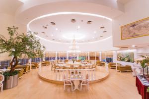 una grande sala da pranzo con tavolo e sedie di Grand Jatra Hotel Balikpapan a Balikpapan