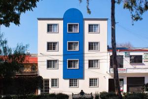 a building with a blue cube on it at La Casa Azul (Zona de Hospitales) in Mexico City