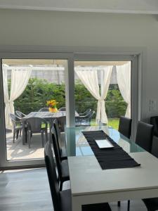 a dining room with a table and chairs and a large window at Villa Carlotta in Salionze
