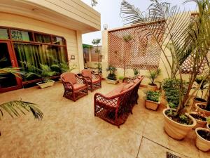 a patio with chairs and potted plants on a house at PANCHHI'S NEST Villa in Amritsar