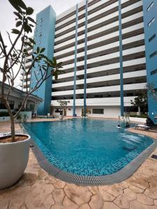 a large swimming pool in front of a building at Mutiara Melaka Beach Resort by LaLuna in Melaka