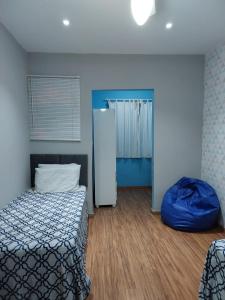 a bedroom with a bed and a blue pillow at Casa da Montanha in Miguel Pereira