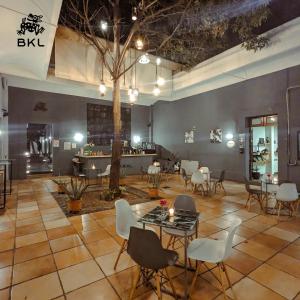 a large room with chairs and tables and a tree at BKL Hotel in Oaxaca City