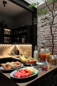 a table with two plates of food and drinks at Aposento Boutique Hotel in Mexico City