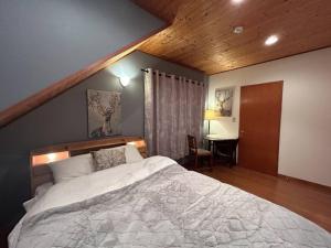 um quarto com uma cama grande e uma mesa em 4月リニューアルOpen! 全室エアコン完備! Deerview Lodge 山中湖 em Yamanakako