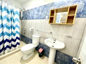 a bathroom with a toilet and a sink at Beyond Island in Moalboal