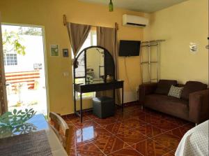 a living room with a couch and a mirror at Rústico Mayan in Cancún