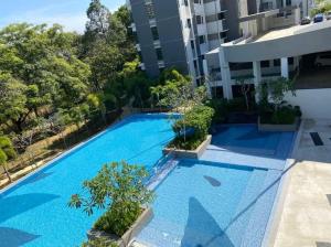 an overhead view of a blue swimming pool in a building at SYG 8 Aura Suite Putrajaya Studio Unit in Putrajaya