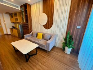 a living room with a couch and a table at Q House- FLC Sea Tower in Quy Nhon