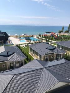 an aerial view of a resort with a pool and the ocean at ЦО Novel Иссык-Куль in Korumdy