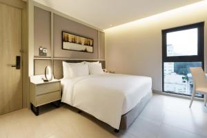 Postel nebo postele na pokoji v ubytování M City Hotel Saigon