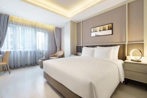 Postel nebo postele na pokoji v ubytování M City Hotel Saigon