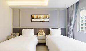 Postel nebo postele na pokoji v ubytování M City Hotel Saigon