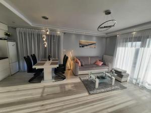a living room with a couch and a table at Apartament 13 Diamond in Dziwnów +24 photos