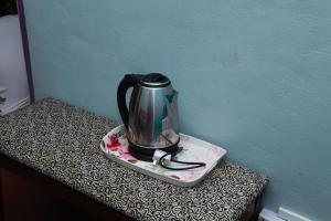 a tea kettle on a plate on a table at Villa Uda @ SIBLINGS Cottage in Setiu