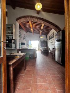 a large kitchen with a large refrigerator and a table at Eroico sul Mare in Portoferraio
