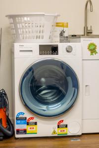 a washing machine with a blue plate on top of it at Cozy 3 bedroom near Hagley Park w/Garage in Christchurch