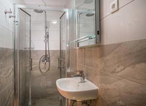 a bathroom with a sink and a shower at Serenity Split Apartments in Split