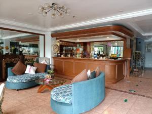 a lobby with two blue chairs and a bar at The Golden Pine Hotel in Baguio